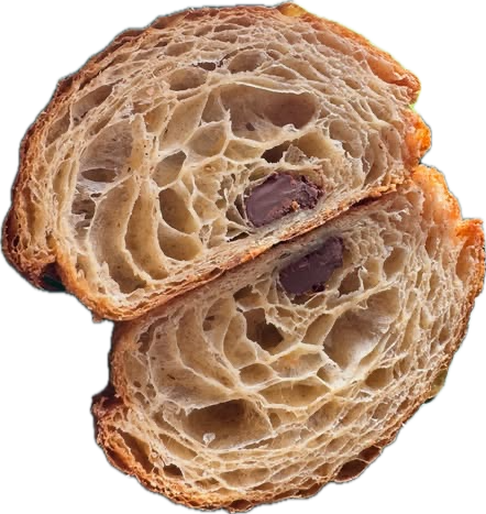 A pain au chocolat cut in half, showing its layered, honeycombed crumb